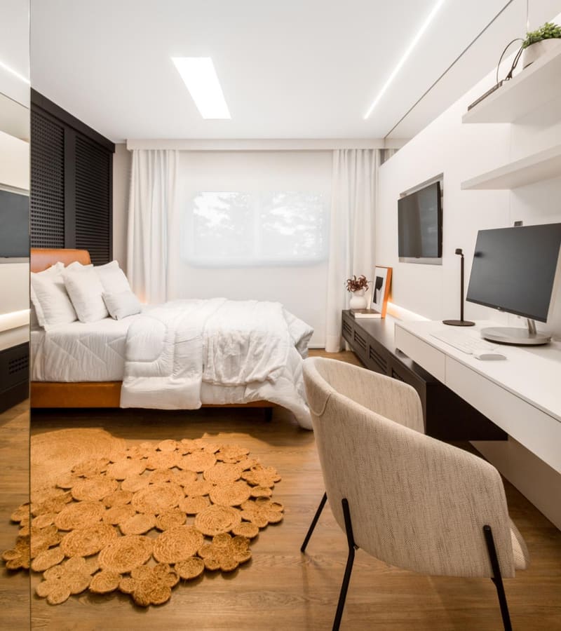 Bedroom with a long built-in desk and wall shelves