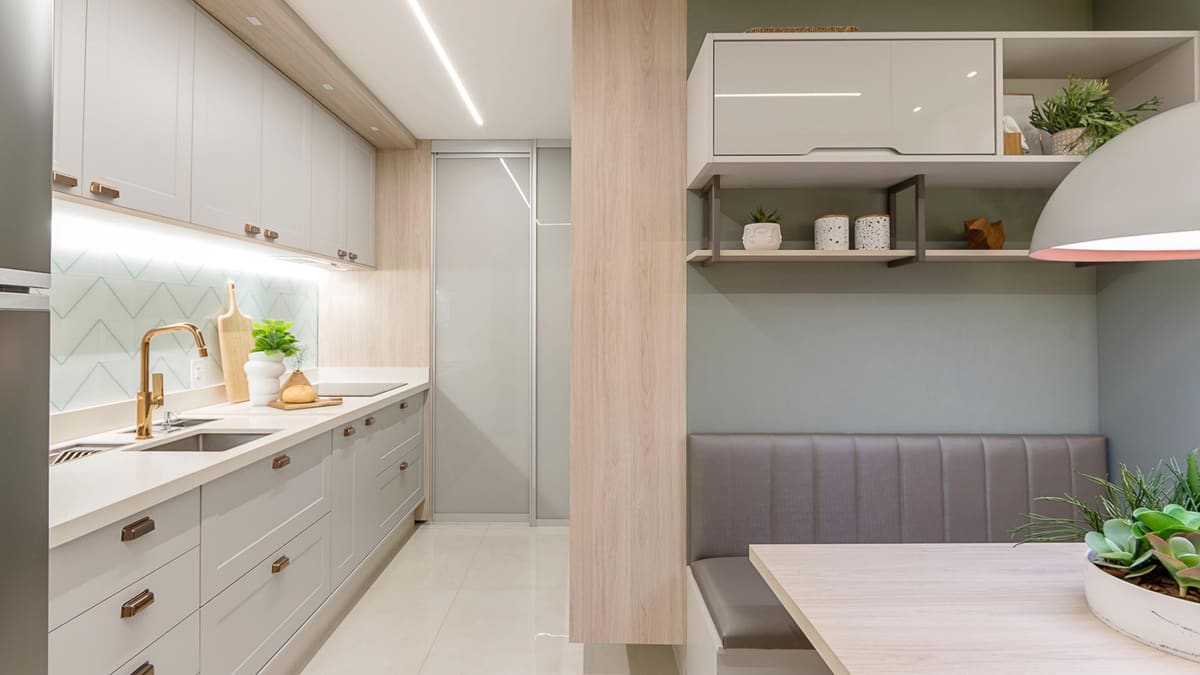 Galley kitchen with shaker cabinets, a herringbone tile backsplash and a built-in banquette