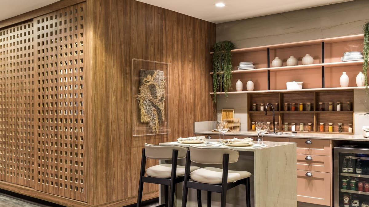 Perforated wood wall panels beside a kitchen bar with open shelving and a wine cooler