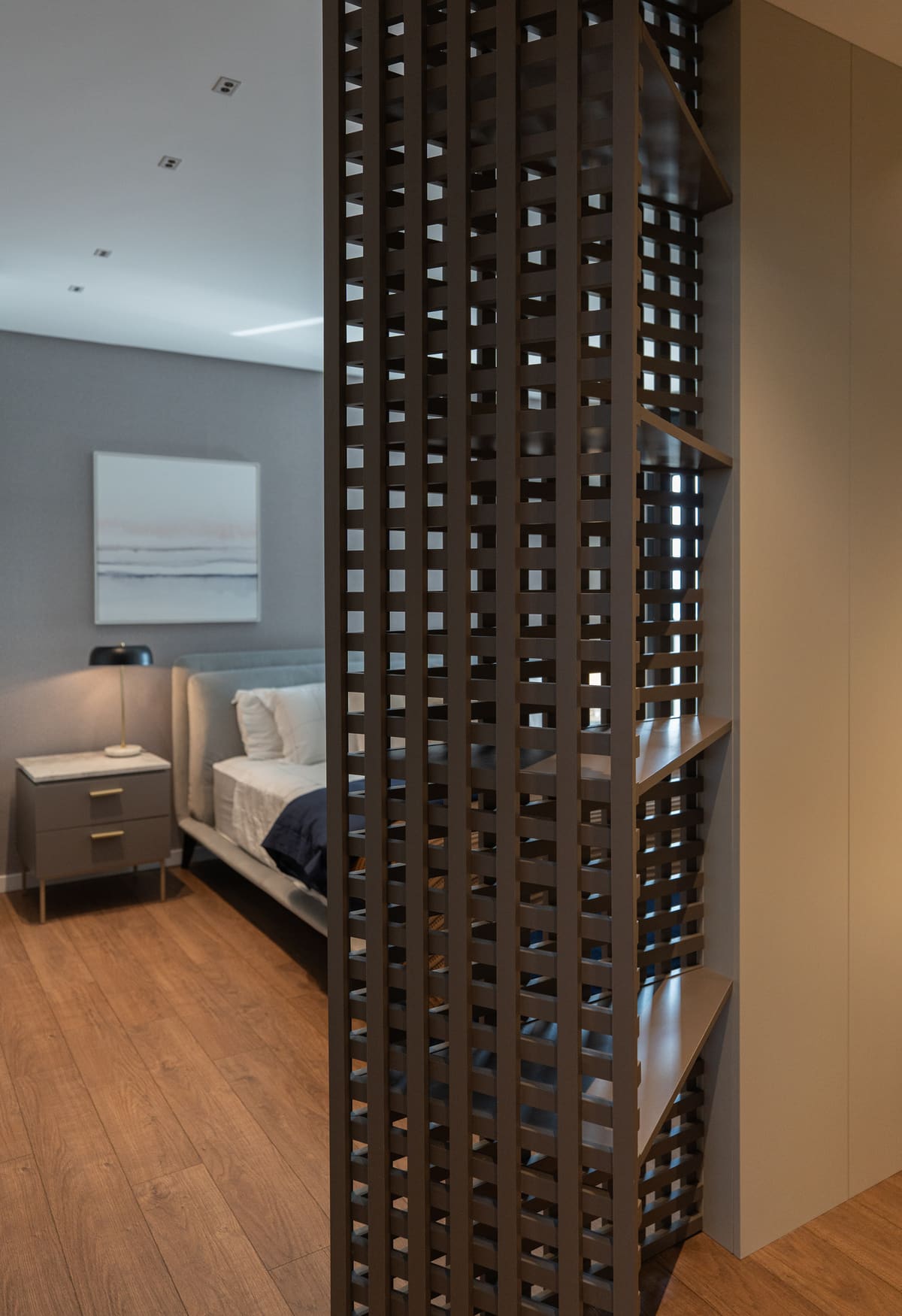 Dark wood lattice screen partitioning a bedroom